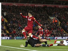 Liverpool's Roberto Firmino, centre, misses a scoring chance against West Bromwich Albion during their English Premier League soccer match at Anfield in Liverpool, England, Wednesday Dec. 13, 2017.