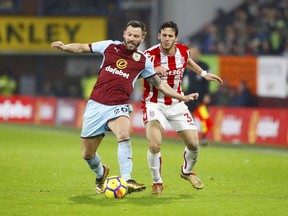 Burnley's Phil Bardsley, left, and Stoke City's Ramadan Sobhi vie for the ball during their English Premier League soccer match Burnley versus Stoke City at Turf Moor, Burnley, England, Tuesday, Dec. 12 2017.