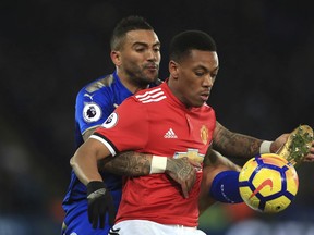 Leicester City's Danny Simpson, left, and Manchester United's Anthony Martial battle for the ball during their English Premier League soccer match at the King Power Stadium, Leicester, England, Saturday, Dec. 23, 2017.