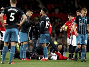 Manchester United's Romelu Lukaku receives treatment on the pitch after suffering a head injury during the English Premier League soccer match Manchester United versus Southampton at Old Trafford, Manchester, England, Saturday Dec. 30, 2017.