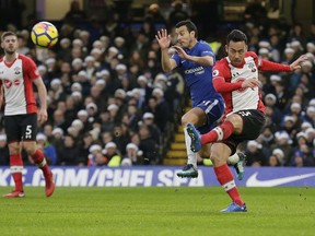 Southampton's Maya Yoshida, right, clears the ball past Chelsea's Pedro during the English Premier League soccer match between Chelsea and Southampton at Stamford Bridge in London, Saturday Dec. 16, 2017.