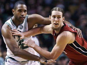 Miami Heat center Kelly Olynyk, right, pushes off Boston Celtics forward Al Horford (42) while trying to receive a pass during the first quarter of an NBA basketball game in Boston, Wednesday, Dec. 20, 2017.