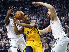 Utah Jazz's Donovan Mitchell (45) drives for the basket between Boston Celtics' Jaylen Brown, left, and Aron Baynes during the second quarter of an NBA basketball game in Boston, Friday, Dec. 15, 2017.