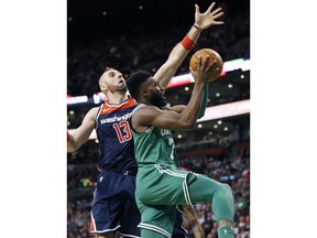 Boston Celtics' Jaylen Brown (7) shoots in front of Washington Wizards' Marcin Gortat (13) during the second quarter of an NBA basketball game in Boston, Monday, Dec. 25, 2017.