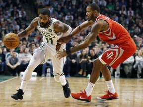 Boston Celtics' Kyrie Irving (11) drives past Houston Rockets' Trevor Ariza during the second quarter of an NBA basketball game in Boston, Thursday, Dec. 28, 2017.