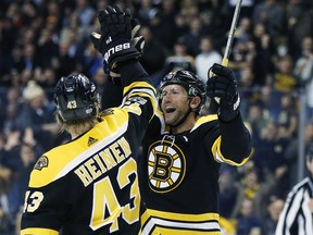 Boston Bruins' David Backes (42) celebrates his goal with teammate Danton Heinen (43) during the second period of an NHL hockey game against the Arizona Coyotes in Boston, Thursday, Dec. 7, 2017.