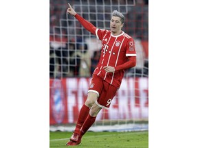 Bayern's Robert Lewandowski celebrates after scoring his side's opening goal during the German Soccer Bundesliga match between FC Bayern Munich and 1.FC Koeln in Munich, Germany, Wednesday, Dec. 13, 2017.