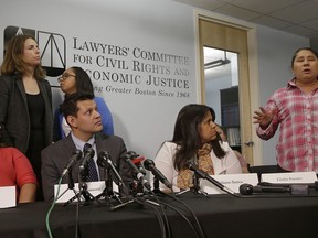 Gladys Fuentes, right, one of five female kitchen workers in Boston speaks about her experiences while detailing a sexual harassment lawsuit the women are filing against McCormick & Schmick's, a national restaurant chain featuring seafood and steaks Tuesday, Dec. 12, 2017, in Boston. The Lawyers' Committee for Civil Rights and Economic Justice, a Boston-based nonprofit representing the women, says the lawsuit alleges a workplace filled with "lewd behavior, sexually inappropriate comments and unwanted touching." Also pictured are plaintiff Marta Romeno (left to right), attorney and interpreter Ivan Espinoza-Madrigal, plaintiff Fabiana Santos, attorney's Rachel Smith (back row left to right) and Sophia Hall.