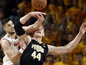 Maryland center Michal Cekovsky, left, of Slovakia, and Purdue center Isaac Haas struggle for a rebound in the first half of an NCAA college basketball game in College Park, Md., Friday, Dec. 1, 2017.