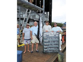 In this Aug. 9, 2016 photo provided by Larry Jock, Phil Heasley, second from left, poses with his catch and team at the White Marlin Open fishing tournament in Ocean City, Md. Heasley caught what was deemed the tournament's only qualifying white marlin, but he was denied over $2.8 million in prize money because he and his crew failed to pass lie-detector tests about whether they followed tournament rules. A federal judge ruled against Heasley in June after a nine-day trial, and Heasley is appealing the ruling.