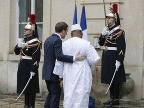 Mali's President Ibrahim Boubacar Keita, left, is welcomed by France's President Emmanuel Macron for conference to support the fight against Jihadist in the African Sahel region at the Chateau of the La Celle Saint-Cloud, west of Paris, France, Wednesday, Dec. 13, 2017. Presidents, princes and diplomats are in France to breathe life into a young African military force that aims to counter the growing Jihad threat in the Sahel region.