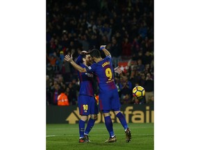 FC Barcelona's Luis Suarez, right, celebrates after scoring with his teammate Lionel Messi during the Spanish La Liga soccer match between FC Barcelona and Deportivo Coruna at the Camp Nou stadium in Barcelona, Spain, Sunday, Dec. 17, 2017.