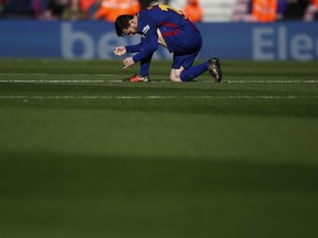 FC Barcelona's Lionel Messi adjust his laces during a Spanish La Liga soccer match between FC Barcelona and Celta Vigo at the Camp Nou stadium in Barcelona, Saturday, Dec. 2, 2017.