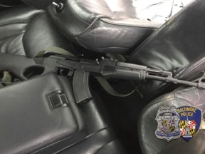 This image made by Baltimore Police chief spokesman T.J. Smith show a weapon inside the car of a shooting suspect in Baltimore, Md., Friday, Dec. 15, 2017. The gunman fleeing police in the car shot wildly at officers and pedestrians across a swath of Baltimore on Friday, as he led cruisers on a chase that looped through streets of the city for at least 20 minutes before he was captured. The gunman injured two people.