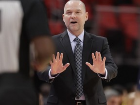 Denver Nuggets head coach Michael Malone disputes a call with referee James Williams during the first half of an NBA basketball game against the Detroit Pistons, Tuesday, Dec. 12, 2017, in Detroit.