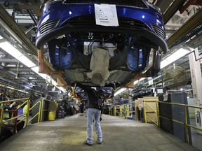 In this Thursday, Nov. 9, 2017, photo, Ford assembly line worker Paul Collins works on a Focus at the Michigan Assembly plant in Wayne, Mich. On Friday, Dec. 22, 2017, the Commerce Department releases its November report on durable goods.
