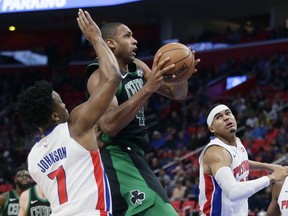 Boston Celtics forward Al Horford, center, goes to the basket against Detroit Pistons forwards Stanley Johnson (7) and Tobias Harris, right, during the first half of an NBA basketball game Sunday, Dec. 10, 2017, in Detroit.