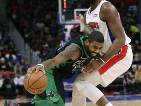 Boston Celtics guard Kyrie Irving, left, drives against Detroit Pistons center Andre Drummond during the first half of an NBA basketball game Sunday, Dec. 10, 2017, in Detroit. AP Photo/Duane Burleson)