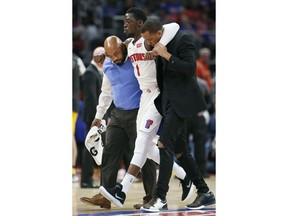 Detroit Pistons guard Reggie Jackson (1) is helped off the court during the second half of an NBA basketball game against the Indiana Pacers and did not return to the game, Tuesday, Dec. 26, 2017, in Detroit. The Pistons defeated the Pacers 107-83.