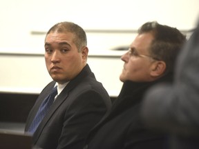 Former Michigan State Trooper Mark Besner, left, sits with his attorney, Richard Convertino, during his arraignment in 36th District Court in Detroit, Thursday, Dec. 21, 2017.   His lawyer has entered a not-guilty plea.  Besner is charged in the death of a Detroit teen and says they'll face the case "head-on."