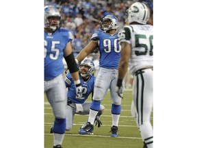 FILE - In this Nov. 7, 2010, file photo, Detroit Lions defensive tackle Ndamukong Suh (90) watches as his extra point attempt misses in the third quarter of an NFL football game against the New York Jets at Ford Field in Detroit. Suh, the NFL's best five-time Pro Bowl defensive tackle, doubles as an emergency place-kicker. (Daniel Mears/Detroit News via AP, File)