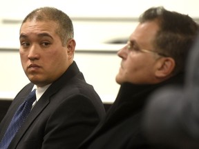 FILE - in this Dec. 21, 2017 file photo, former Michigan State Trooper Former Michigan State Trooper Mark Bessner, left, sits with his attorney, Richard Convertino, during his arraignment in 36th District Court in Detroit. Bessner is charged with murder in the death of Damon Grimes after he fired a Taser at the teenager who crashed an all-terrain vehicle and died. State police wanted to suspend Bessner for 10 days for firing his Taser twice at a handcuffed man who was running away in 2016, according to records obtained by the Associated Press. He was also questioned in a separate 2014 taser incident.