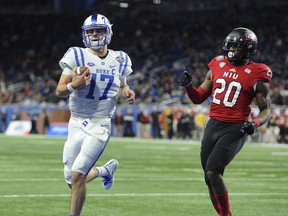 Duke quarterback Daniel Jones (17) runs for a touchdown past Northern Illinois safety Mycial Allen (20) during the first quarter of the Quick Lane Bowl NCAA college football game, Tuesday, Dec. 26, 2017, in Detroit.