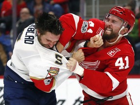Florida Panthers defenseman Aaron Ekblad (5) and Detroit Red Wings right wing Luke Glendening (41) fight in the second period of an NHL hockey game Monday, Dec. 11, 2017, in Detroit.