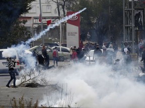 Palestinians clash with Israeli troops following a protest against U.S. President Donald Trump's decision to recognize Jerusalem as the capital of Israel, in the West Bank City of Nablus, Wednesday, Dec. 13, 2017.
