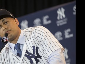 New York Yankees outfielder Giancarlo Stanton speaks to the press at the MLB winter meetings in Orlando, Fla., on Dec. 11.