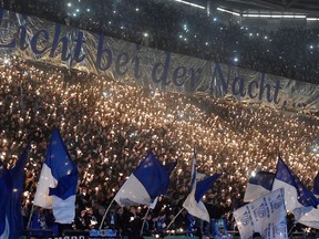 Thousands of Schalke supporters hold little sparkler prior the German soccer cup match between FC Schalke 04 and 1. FC Cologne in Gelsenkirchen, Germany, Tuesday, Dec. 19, 2017.