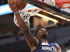 Minnesota Timberwolves guard forward Jimmy Butler (23) shoots against the Los Angeles Clippers in the first quarter of an NBA basketball game on Sunday, Dec. 3, 2017, in Minneapolis.
