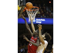 Rutgers guard Issa Thiam (35) and Minnesota forward Jordan Murphy (3) go for a rebound during the first half of an NCAA college basketball game Sunday, Dec. 3, 2017, in Minneapolis.