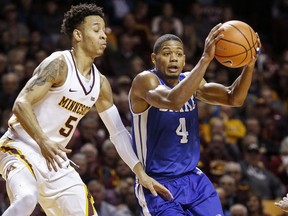 Drake guard De'Antae McMurray (4) looks to pass around Minnesota guard Amir Coffey (5) in the first half of an NCAA college basketball game Monday, Dec. 11, 2017, in Minneapolis.