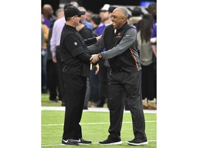 Minnesota Vikings head coach Mike Zimmer, left, talks with Cincinnati Bengals head coach Marvin Lewis, right, before an NFL football game, Sunday, Dec. 17, 2017, in Minneapolis.