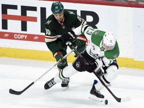 Dallas Stars' Mattias Janmark (13), of Sweden, has the puck against Minnesota Wild's Chris Stewart (10) during the first period of an NHL hockey game Wednesday, Dec. 27, 2017, in St. Paul, Minn.