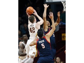 Minnesota's Michael Hurt, left, shoots as Florida Atlantic's Ronald Delph defends in the first half of an NCAA college basketball game Saturday, Dec. 23, 2017, in Minneapolis.