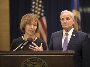 Minnesota Gov. Mark Dayton listens to Lt. Gov. Tina Smith as she was named to replace fellow Democrat Al Franken in the U.S. Senate on Wednesday, Dec. 13, 2017 in St. Paul, Minn.   Franken announced his resignation last week amid growing sexual misconduct allegations.