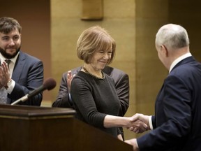 Minnesota Gov. Mark Dayton shakes hands with Lt. Gov. Tina Smith after a news conference, as she was named to replace fellow Democrat Al Franken in the U.S. Senate on Wednesday, Dec. 13, 2017 in St. Paul, Minn.  Franken announced his resignation last week amid growing sexual misconduct allegations.
