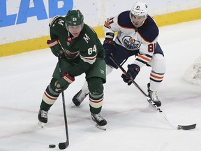 Minnesota Wild's Mikael Granlund (64) controls the puck against Edmonton Oilers' Johann Auvitu (81) in the first period of an NHL hockey game Saturday, Dec. 16, 2017, in St. Paul, Minn.