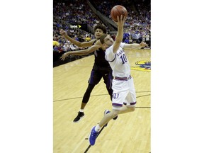 Kansas' Sviatoslav Mykhailiuk (10) shoots in front ofWashington's Matisse Thybulle (4) during the first half of an NCAA college basketball game Wednesday, Dec. 6, 2017, in Kansas City, Mo.