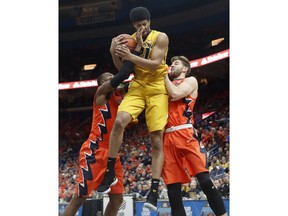 Missouri's Jordan Barnett, center, pulls down a rebound between Illinois' Leron Black, left, and Michael Finke during the first half of an NCAA college basketball game Saturday, Dec. 23, 2017, in St. Louis.