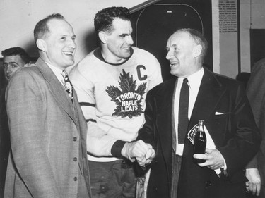 Syl Apps (centre) is shown with Hap Day (left) and Conn Smythe in 1947.