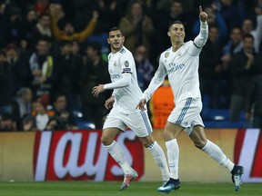 Real Madrid's Cristiano Ronaldo, right, celebrates with team mate Real Madrid's Theo Hernandez after scoring his side's second goal during the Champions League Group H soccer match between Real Madrid and Borussia Dortmund at the Santiago Bernabeu stadium in Madrid, Spain, Wednesday, Dec. 6, 2017.