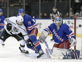 New York Rangers defenseman Brady Skjei (76) checks Los Angeles Kings left wing Kyle Clifford (13) as Rangers goalie Henrik Lundqvist (30) deflects the puck during the first period of an NHL hockey game Friday, Dec. 15, 2017, at Madison Square Garden in New York.