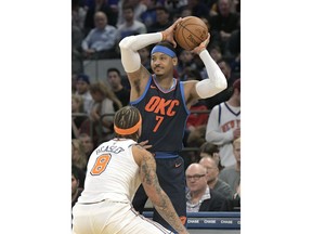 Oklahoma City Thunder forward Carmelo Anthony (7) looks to pass the ball as he is guarded by New York Knicks forward Michael Beasley (8) during the second quarter of an NBA basketball game Saturday, Dec.16, 2017, at Madison Square Garden in New York.