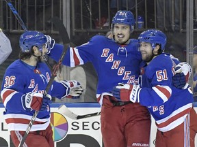 New York Rangers center David Desharnais (51) celebrates his goal with Chris Kreider (20) and Mats Zuccarello (36) during the second period of an NHL hockey game against the Carolina Hurricanes on Friday, Dec. 1, 2017, at Madison Square Garden in New York.