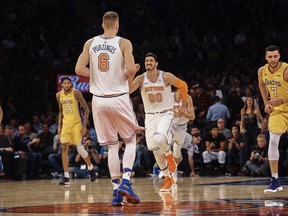 New York Knicks' Enes Kanter (00), celebrates with Kristaps Porzingis (6) during the first half of an NBA basketball game against Los Angeles Lakers at Madison Square Garden in New York, Tuesday, Dec. 12, 2017.