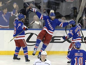 New York Rangers right wing Rick Nash (61) celebrates his goal with defenseman Marc Staal (18) and right wing Mats Zuccarello (36) during the third period of an NHL hockey game against the Los Angeles Kings Friday, Dec. 15, 2017, at Madison Square Garden in New York.