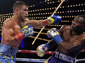 Vasyl Lomachenko punches Guillermo Rigondeaux during the third round of a WBO junior lightweight title boxing match Saturday, Dec. 9, 2017, in New York.